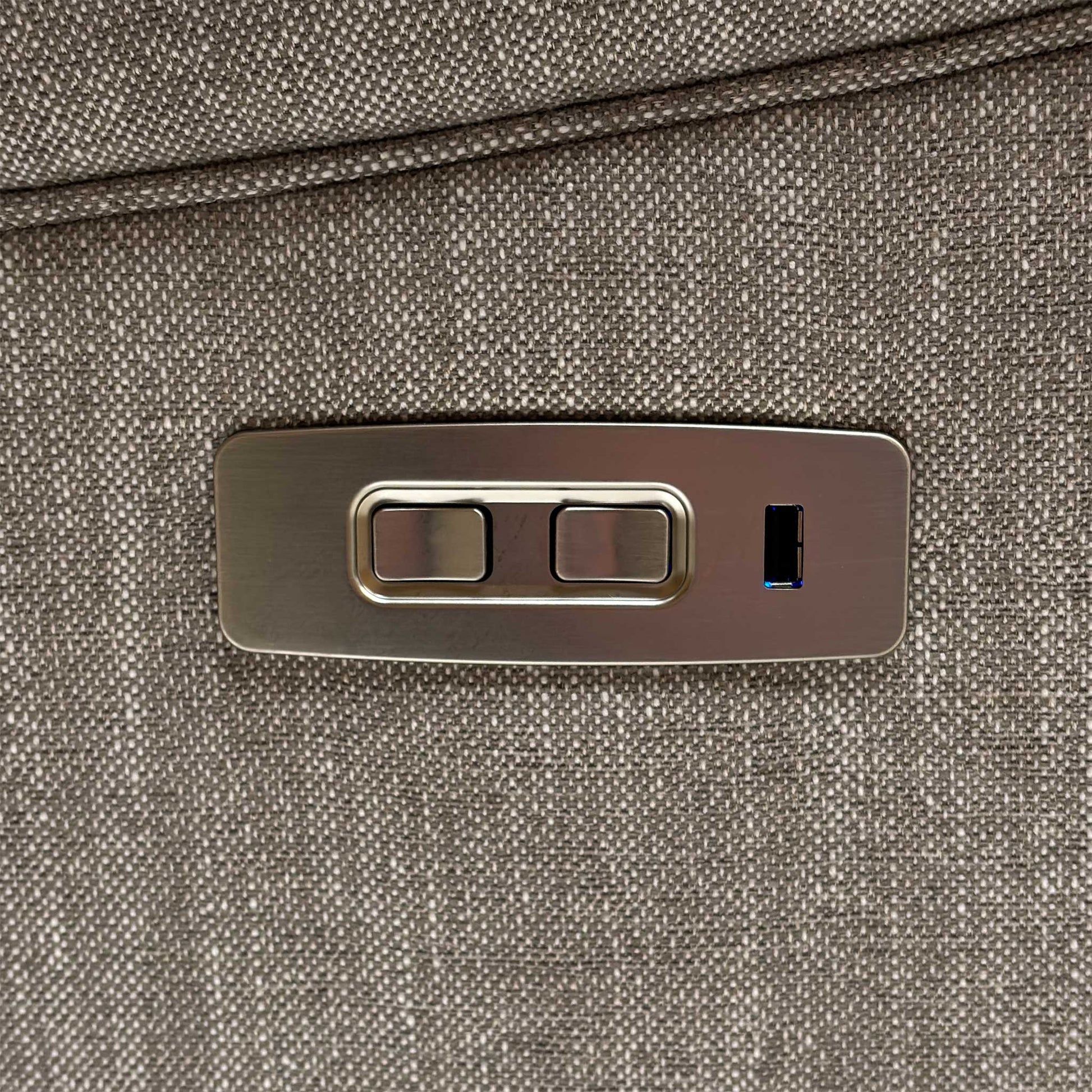 Close-up of the integrated brushed chrome side control panel, featuring intuitive buttons for seamless power recline adjustments.