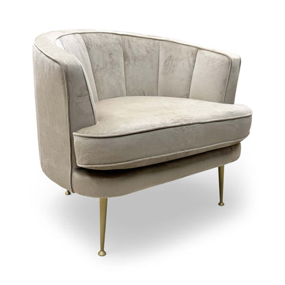 Full view of the ‘Enchanted’ accent chair in latte sensual velvet, showing the rounded backrest and plush seat cushion.