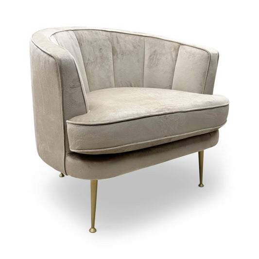 Full view of the ‘Enchanted’ accent chair in latte sensual velvet, showing the rounded backrest and plush seat cushion.