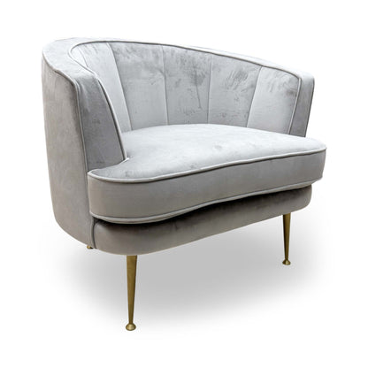 Full view of the DFS ‘Enchanted’ Accent Chair in silver sensual velvet, featuring a modern curved back and plush upholstered finish.