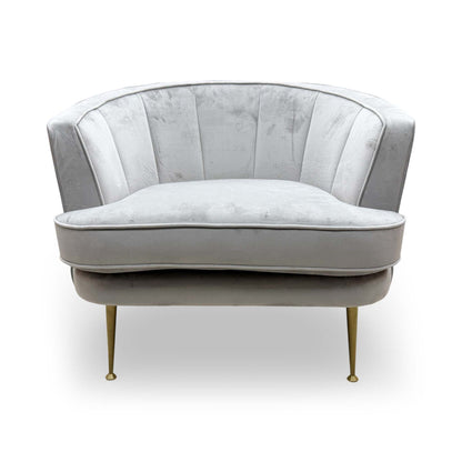 Front view of the DFS ‘Enchanted’ Accent Chair in silver sensual velvet, featuring a modern curved back and plush upholstered finish.