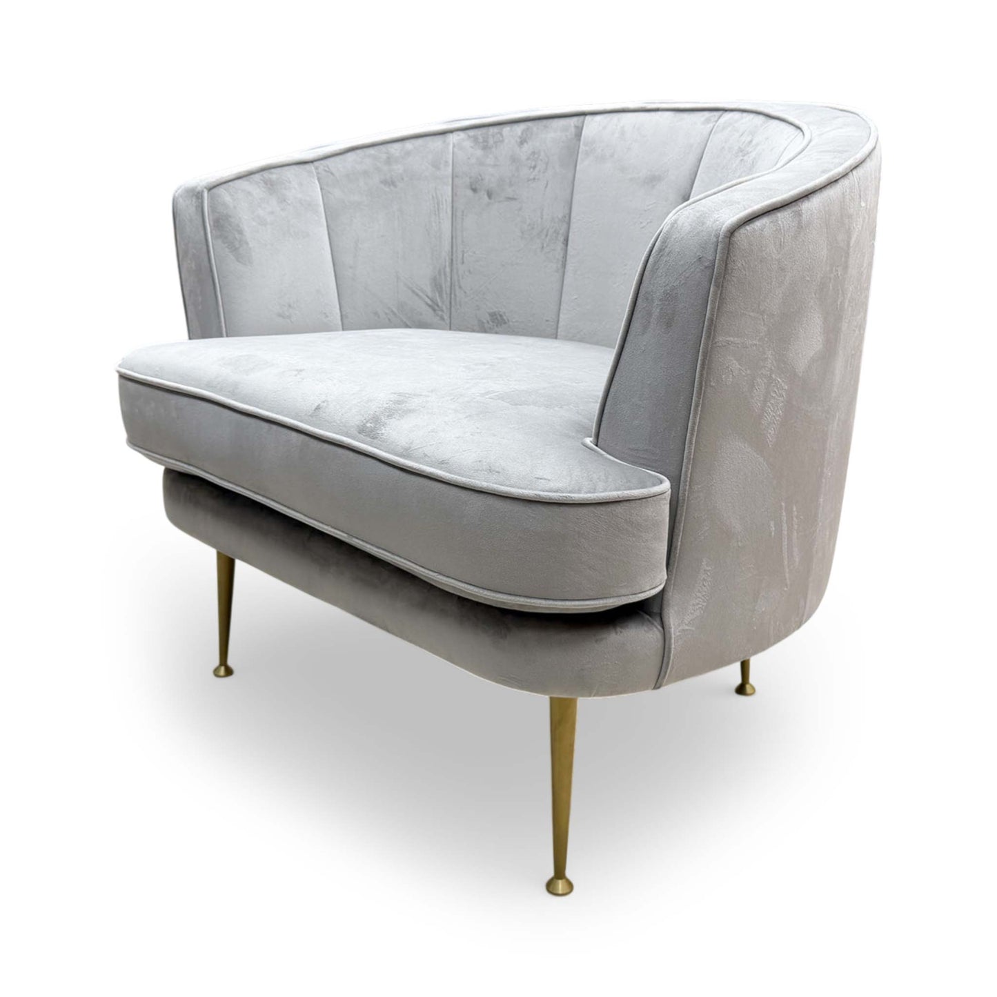 Side profile of the ‘Enchanted’ accent chair, demonstrating the comfortable back tilt and clean upholstered lines.