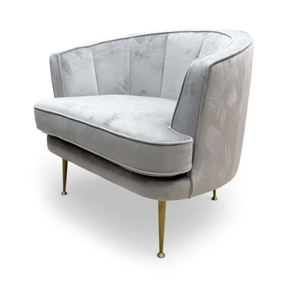 Side profile of the ‘Enchanted’ accent chair, demonstrating the comfortable back tilt and clean upholstered lines.
