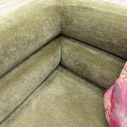 Detailed close-up of the olive green chenille fabric, illustrating the luxurious texture and durable weave of the armchair.
