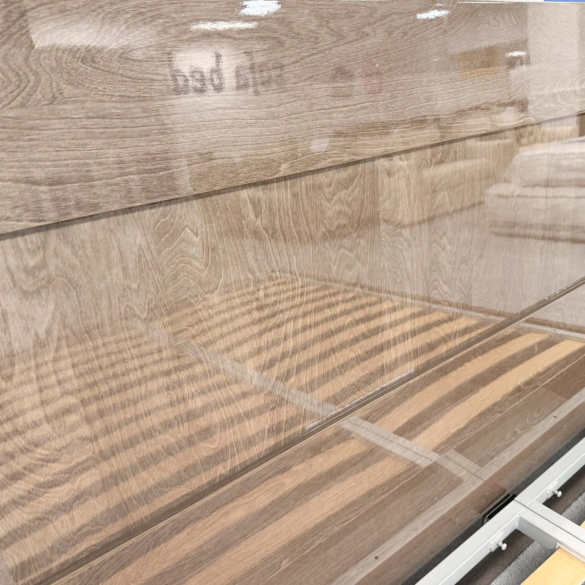 Detailed close-up of the silver birch wood grain and the ambient LED light strip built into the headboard of the Venezia bed.
