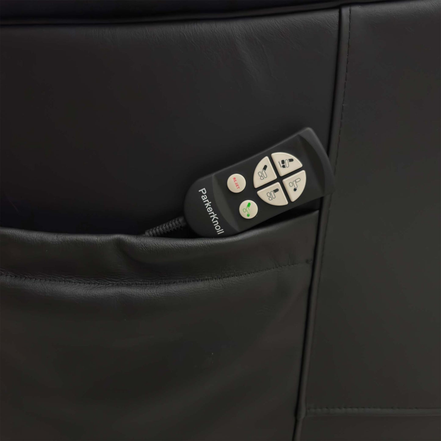 Detail shot of the wired remote control and integrated USB port, showing the simple interface used to operate the chair's movements.