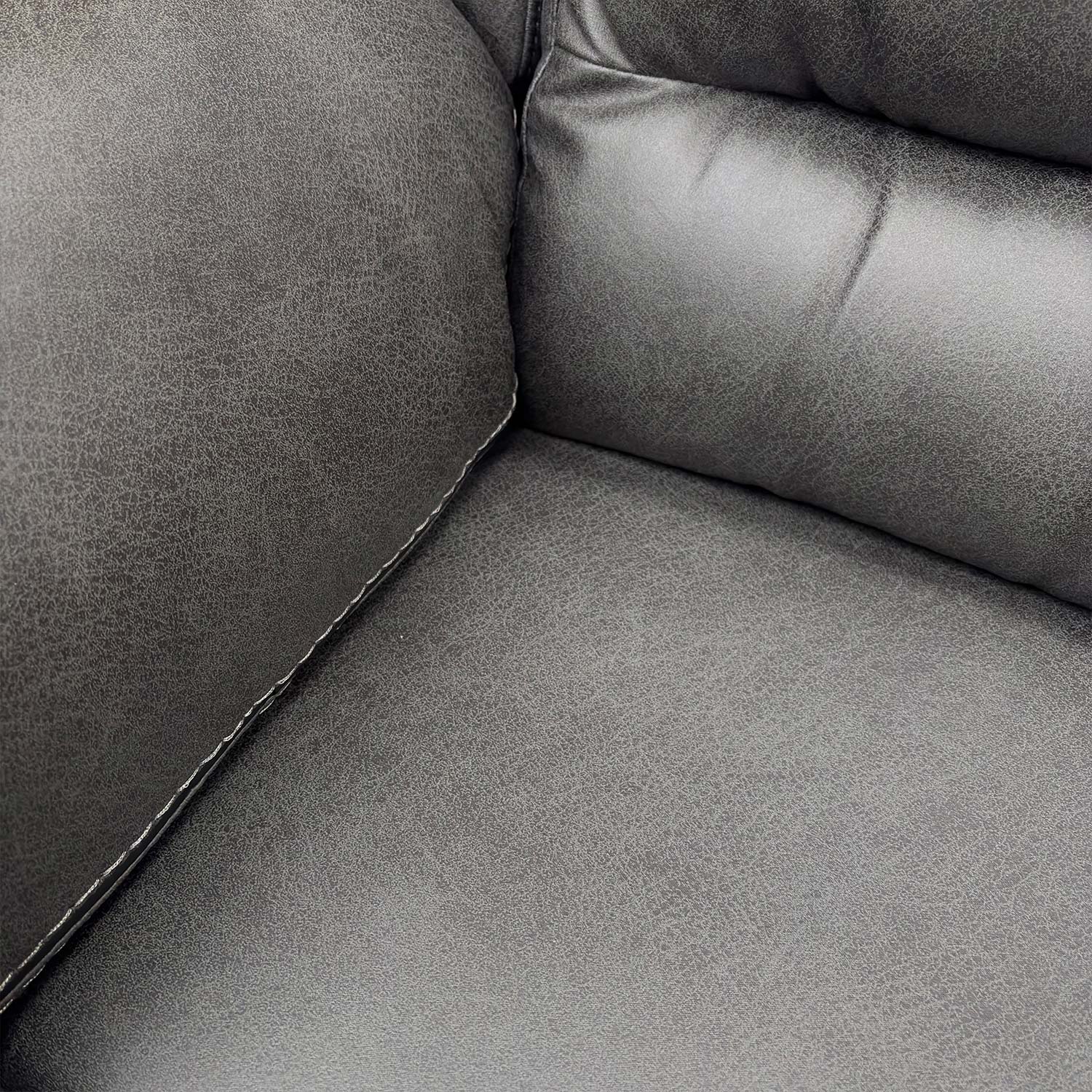 Close-up of the stitching and finish on the charcoal grey fabric armrest.