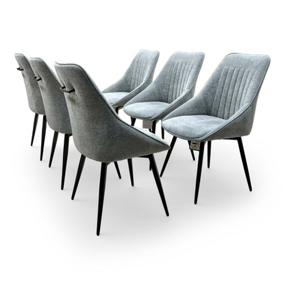 Rear view of the 'Crete' dining chair showcasing the decorative vertical fluting on the dark grey upholstery.