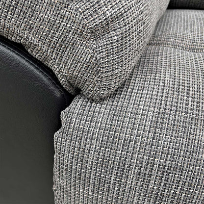 Close-up of the durable charcoal fabric upholstery and stitched detailing.