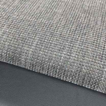 Close-up of the durable charcoal fabric upholstery and stitched detailing.