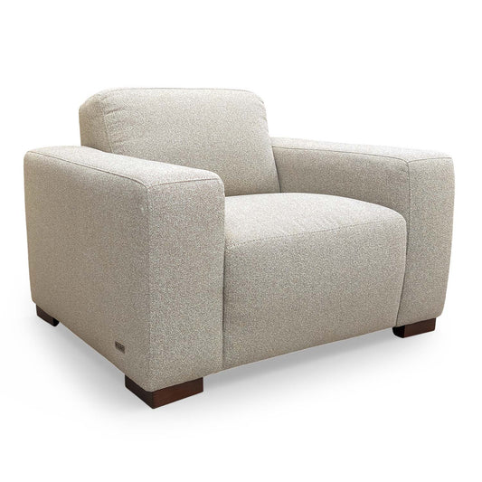 Full view of the Very Michelle Keegan Home ‘Cortes’ armchair in natural fabric, featuring a sleek, contemporary design.