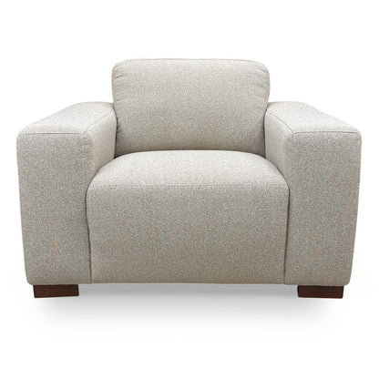 Front view of the Very Michelle Keegan Home ‘Cortes’ armchair in natural fabric, featuring a sleek, contemporary design.