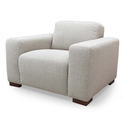 Side profile of the Michelle Keegan Home ‘Cortes’ armchair, showcasing the modern armrest design and clean lines.