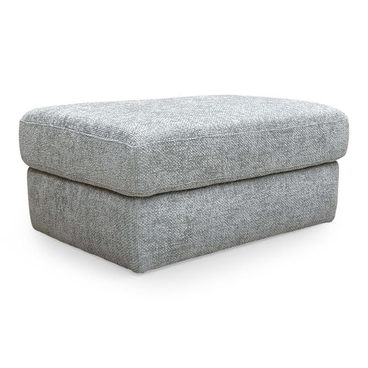 Full view of the Very ‘Avena’ footstool in soft grey fabric, featuring a clean rectangular design and subtle stitching.