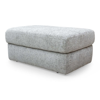 Side view of the ‘Avena’ footstool, showcasing the sleek profile and professional upholstery finish.