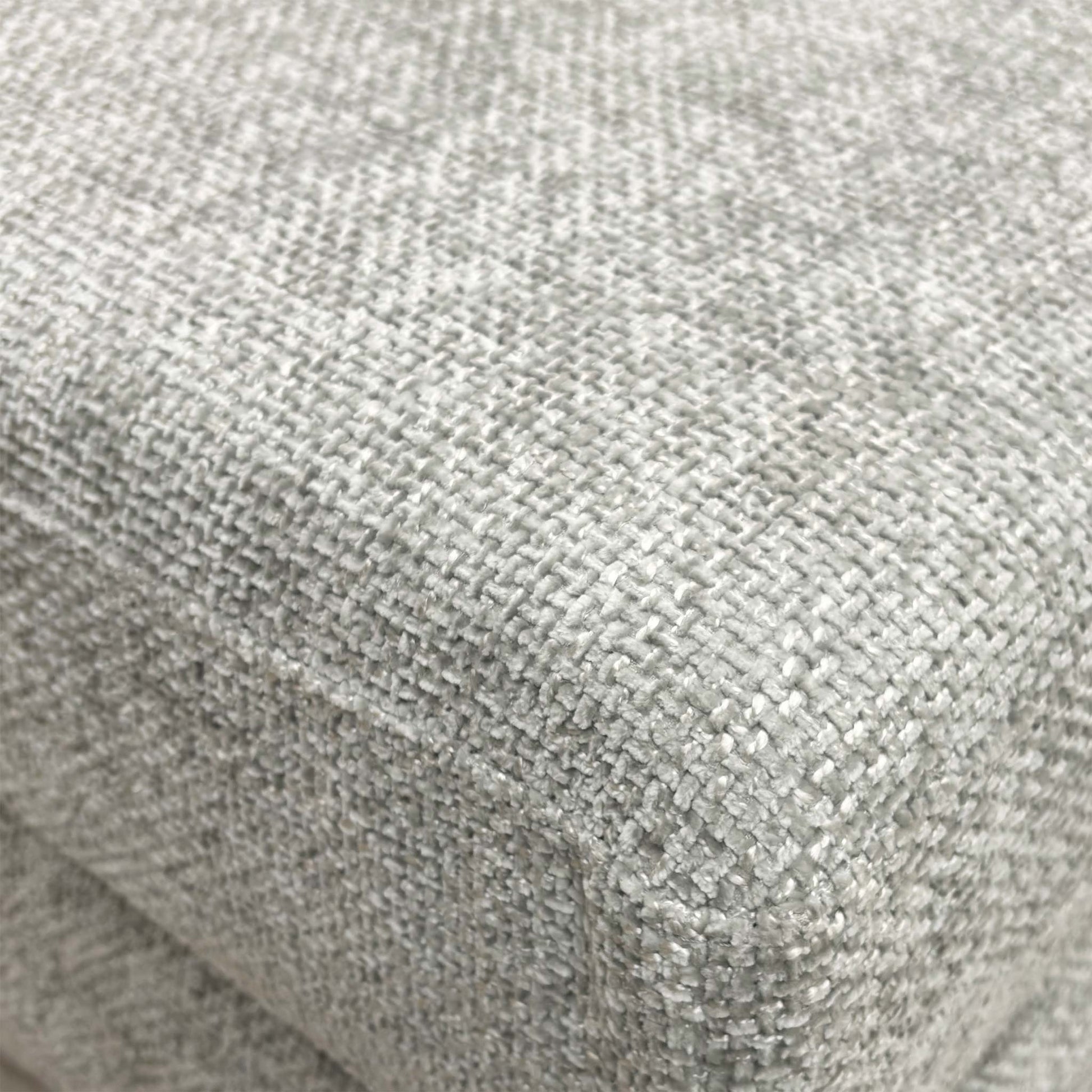 Detailed close-up of the grey fabric on the ‘Avena’ footstool, illustrating the high-quality weave and material durability.