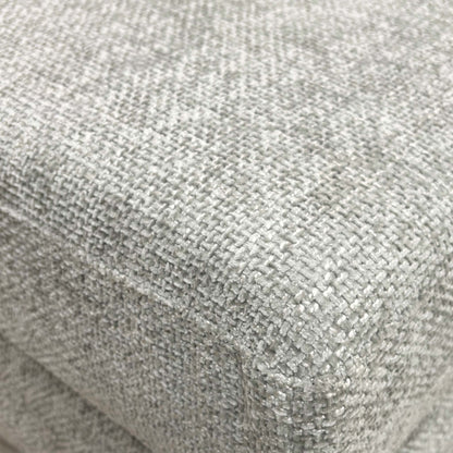 Detailed close-up of the grey fabric on the ‘Avena’ footstool, illustrating the high-quality weave and material durability.