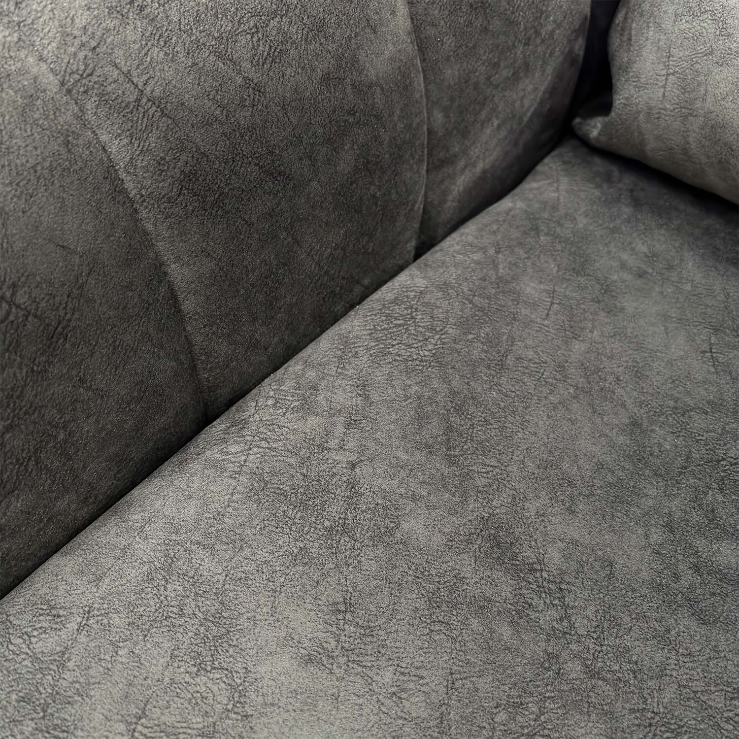 Detailed close-up of the charcoal velvet upholstery, illustrating the soft texture and high-quality finish.