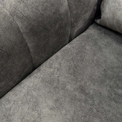 Detailed close-up of the charcoal velvet upholstery, illustrating the soft texture and high-quality finish.
