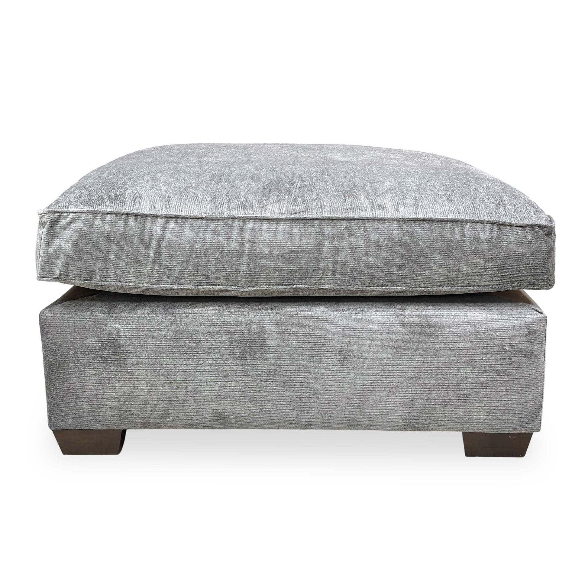 Side profile of the ‘Rosie’ footstool showing the clean lines and uniform upholstery from top to base.