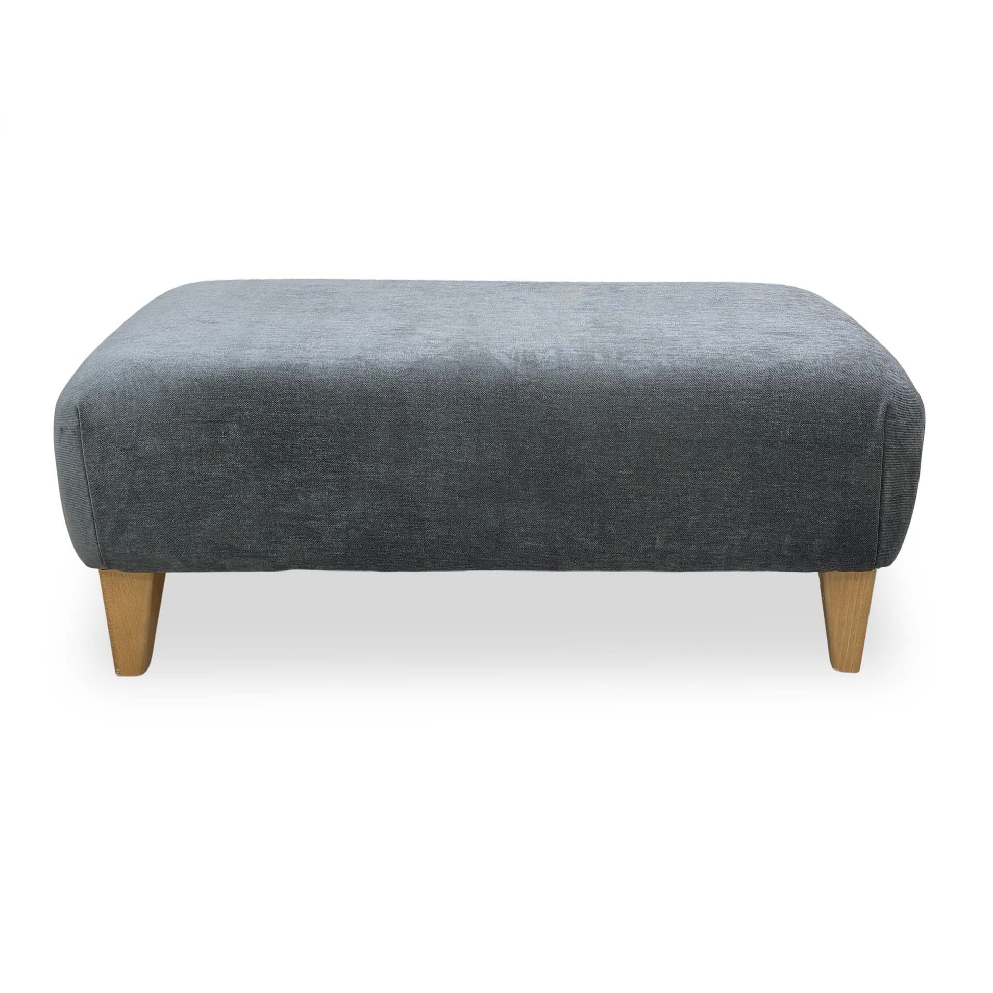 Side profile of the Garda footstool showing the low-block feet and clean contemporary silhouette.