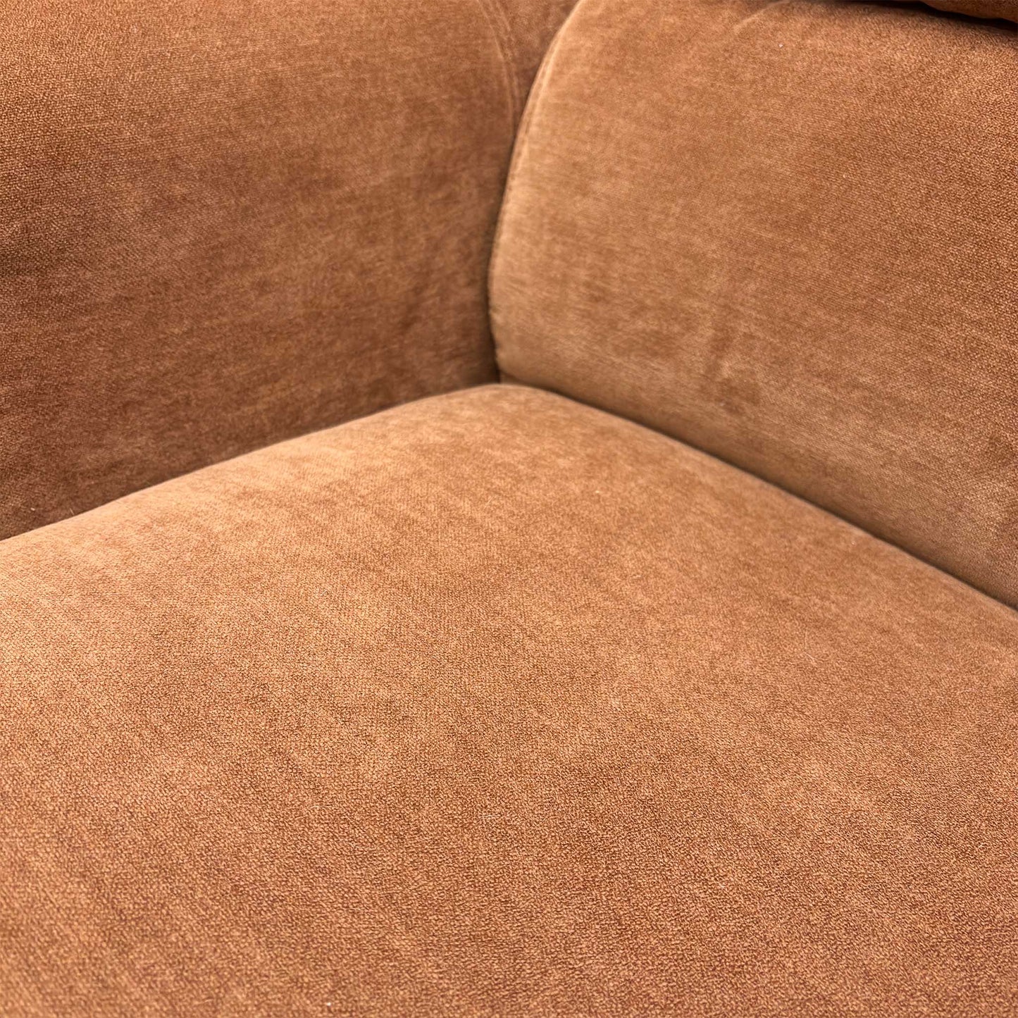 Close-up of the seating area showing the luxurious texture of the R500 caramel fabric.