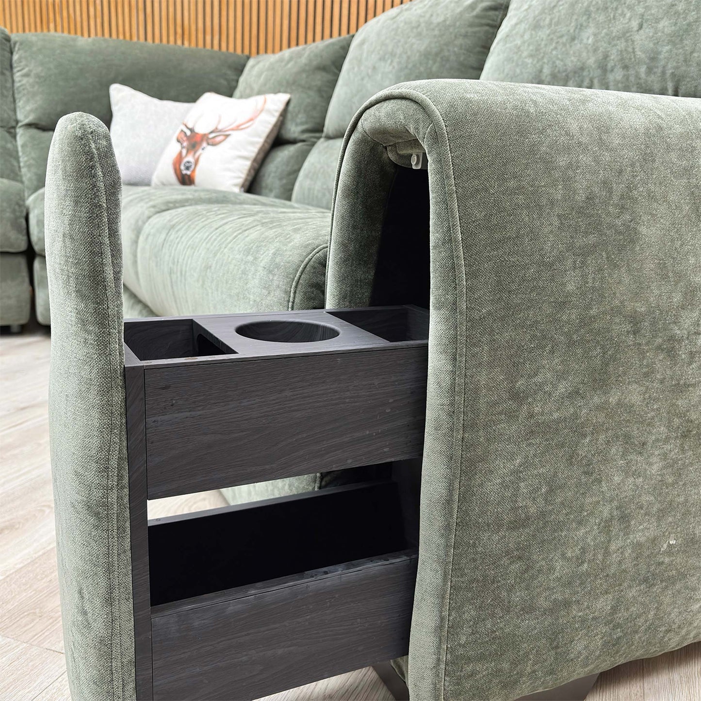 Close-up of the storage arm functionality featuring the hidden drawer and beverage holder.
