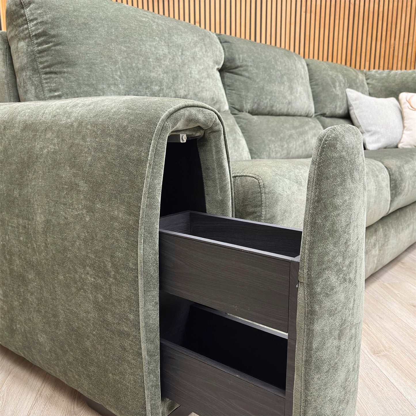 Close-up of the storage arm functionality featuring the hidden drawer and beverage holder.