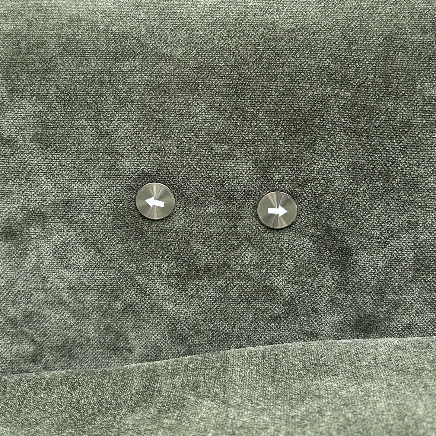 Close-up of the power recliner controls located on the side of the forest green fabric arm.