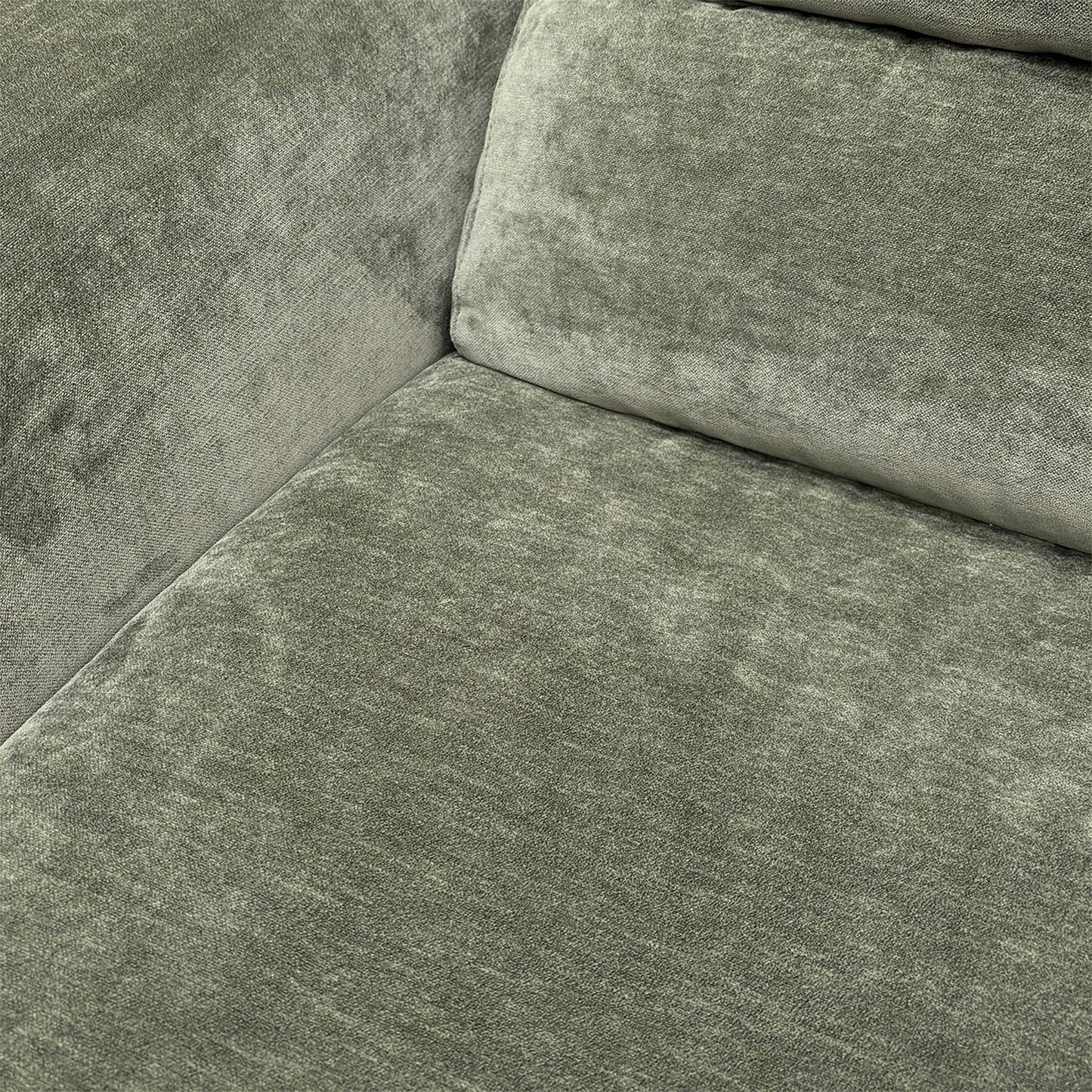 Detailed shot of the plush forest green upholstery fabric and durable stitched seams.