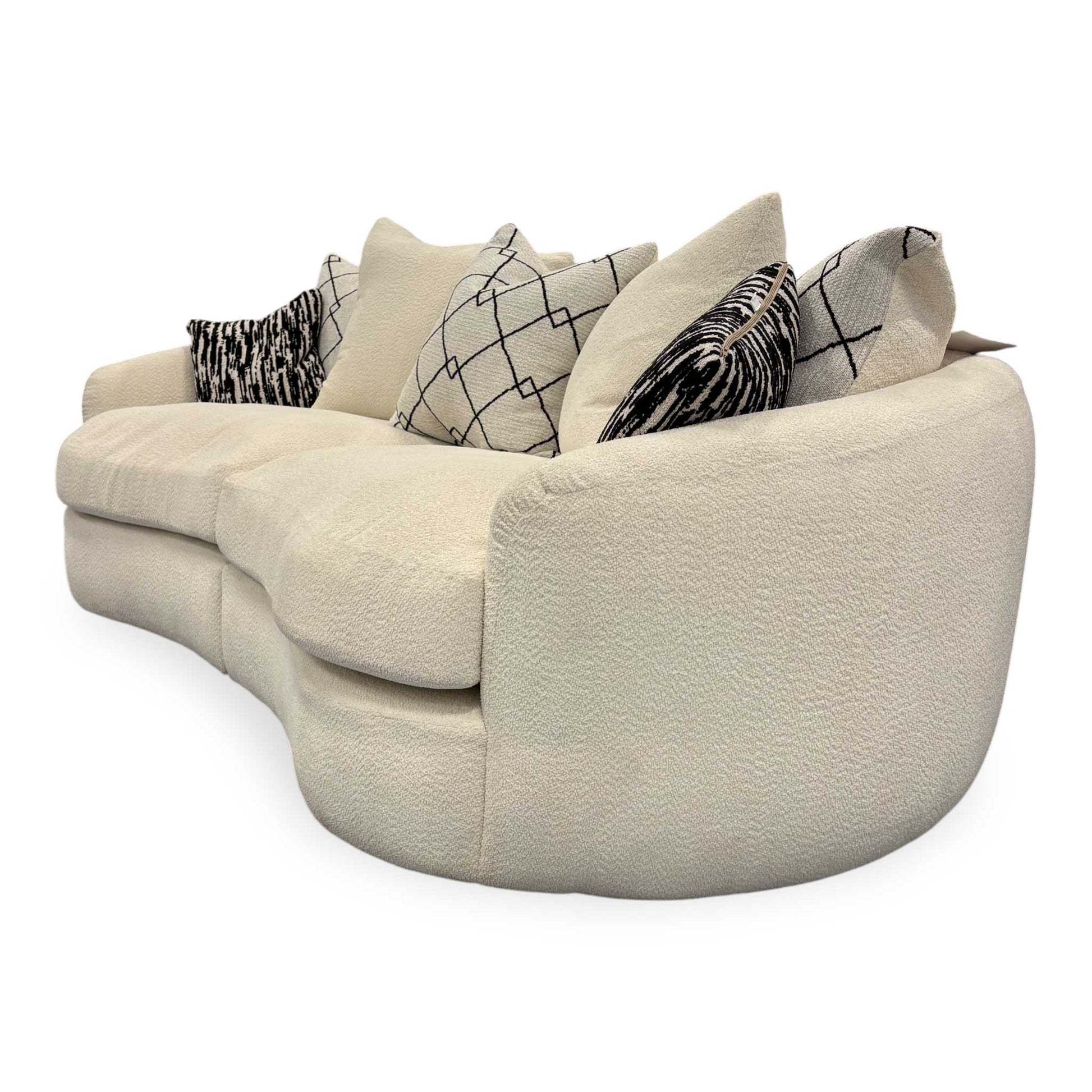 Side view of the Fabb ‘Bow’ 4-seater sofa in Ecru Ivory Boucle fabric featuring a curved backrest.