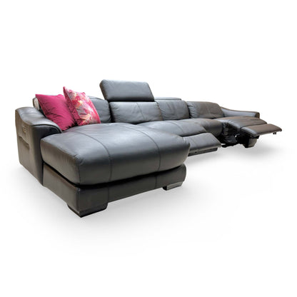 Side profile of the ‘Xavier’ black leather sofa with the power recliner fully extended, showing the range of motion.