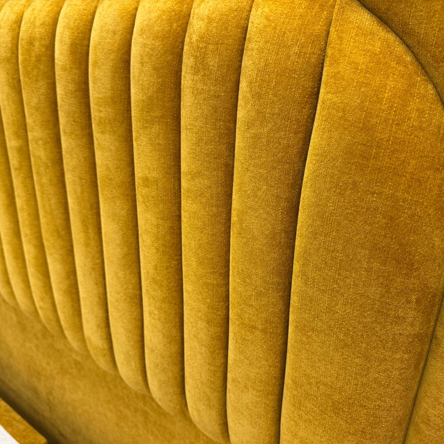 Close-up of the Aston Saffron fabric, showcasing the rich yellow tone and premium woven texture of the bed set.