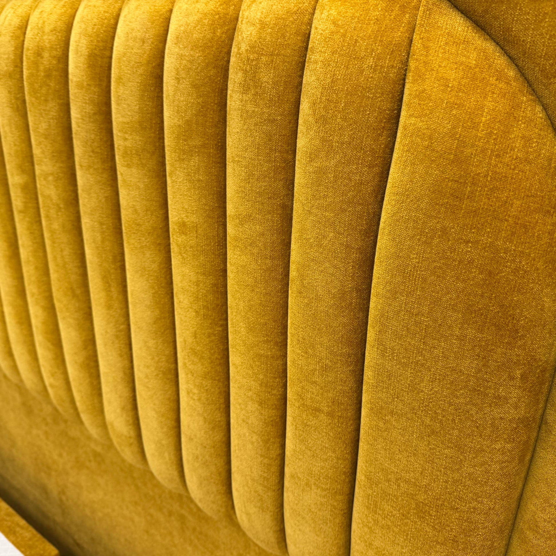 Close-up of the Aston Saffron fabric, showcasing the rich yellow tone and premium woven texture of the bed set.