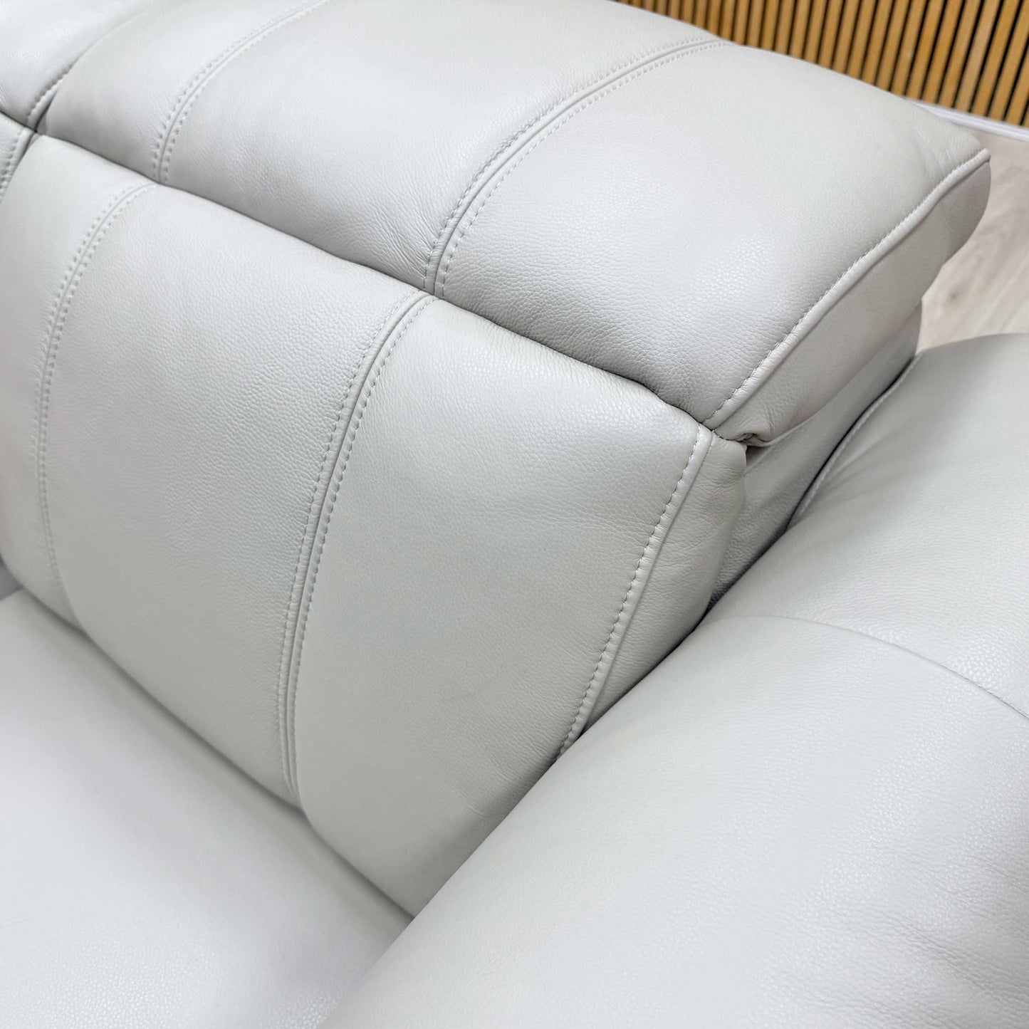 Detailed texture shot of the high-quality Cat-60/23 lead grey leather upholstery and stitching.