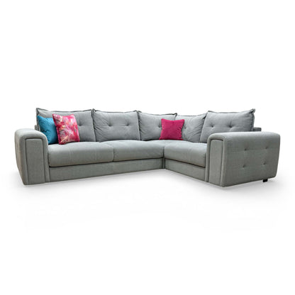 Front-facing view of the ‘Goliath’ Oxford Grey right-hand facing corner sofa featuring plush pillow-back cushions.