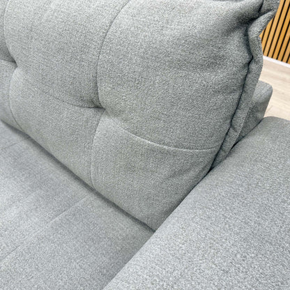 Close-up of the modern button-tufted upholstery and textured Oxford Grey fabric on the Goliath sofa.