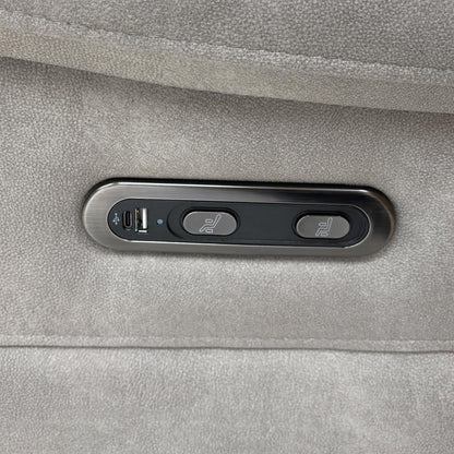 Close-up of the integrated chrome power reclining controls located on the side of the velvet armrest.