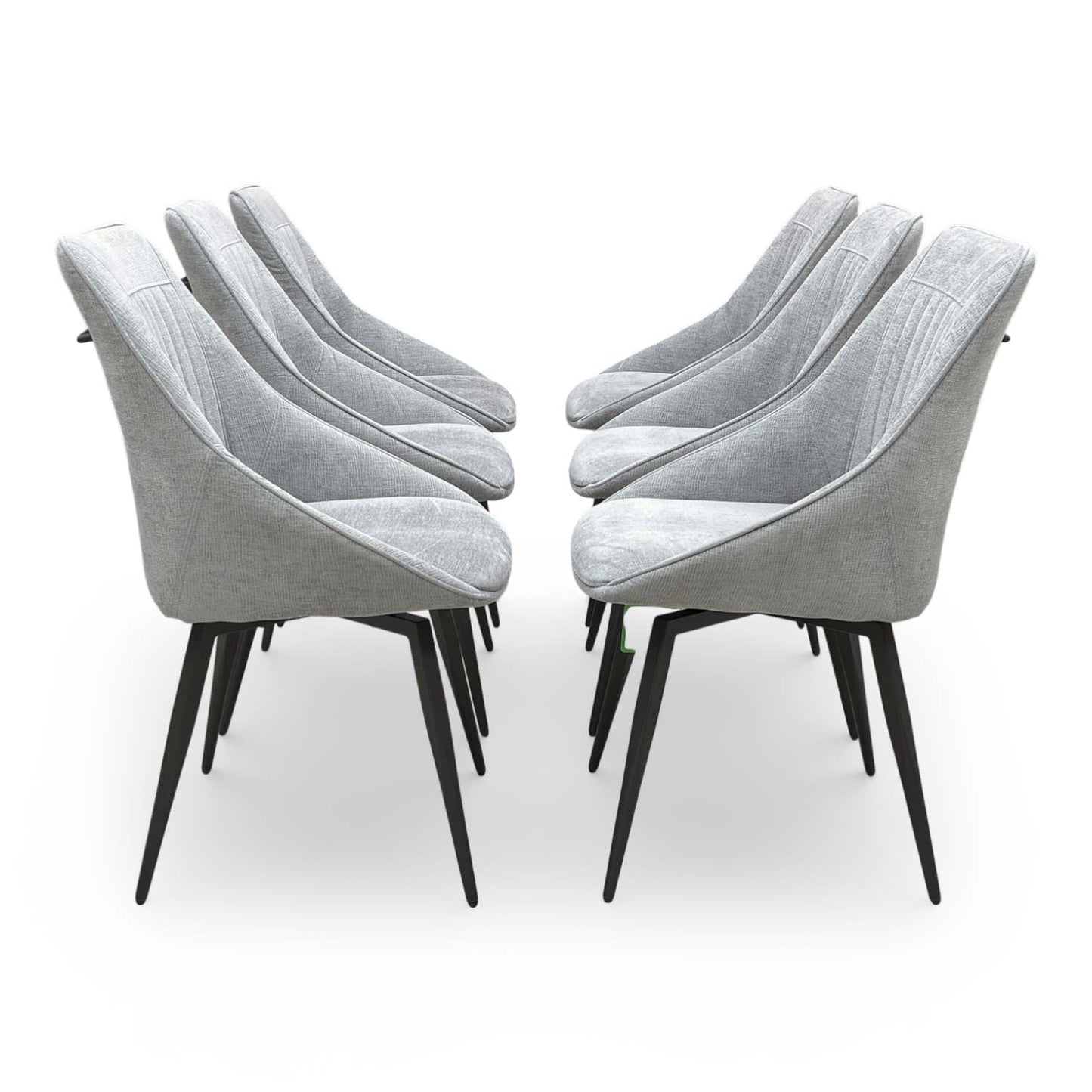Side view of the ‘Crete’ dining chair showing the slender matt black metal legs and modern profile.