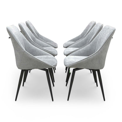 Side view of the ‘Crete’ dining chair showing the slender matt black metal legs and modern profile.