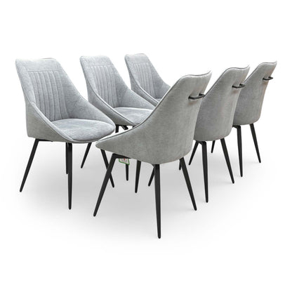 Full view of the ‘Crete’ silver fabric swivel dining chairs set of 6 with curved fluted backs.