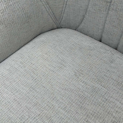 Close-up of the vertical fluted stitching and premium silver fabric upholstery on the chair back.