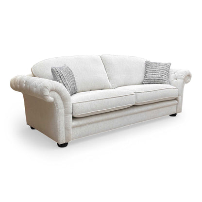 Side profile of the ‘Vincent’ sofa, showing the clean lines of the armrests and supportive back cushions.