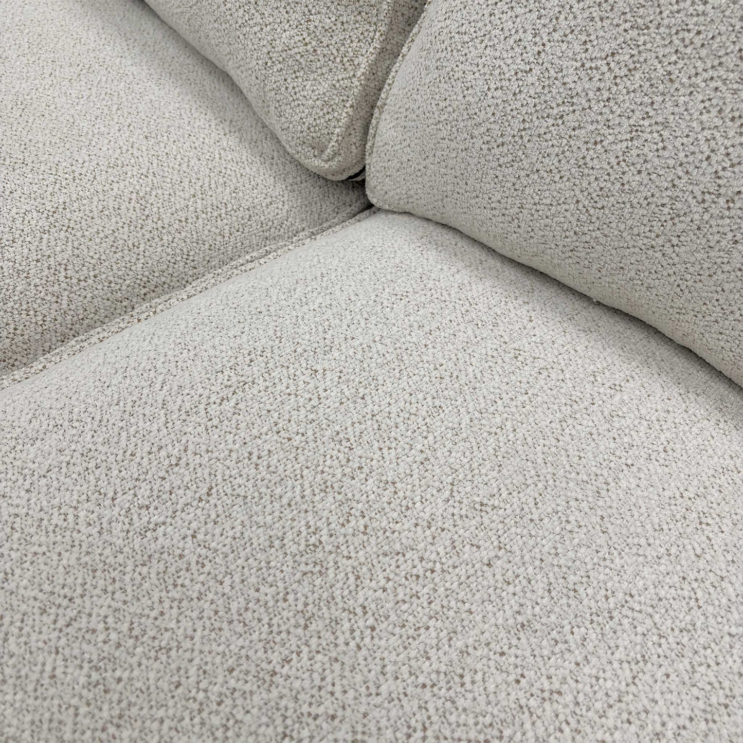 Close-up of the high-quality beige soft woven upholstery fabric and textured weave detail.