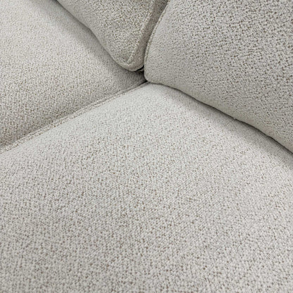 Close-up of the high-quality beige soft woven upholstery fabric and textured weave detail.
