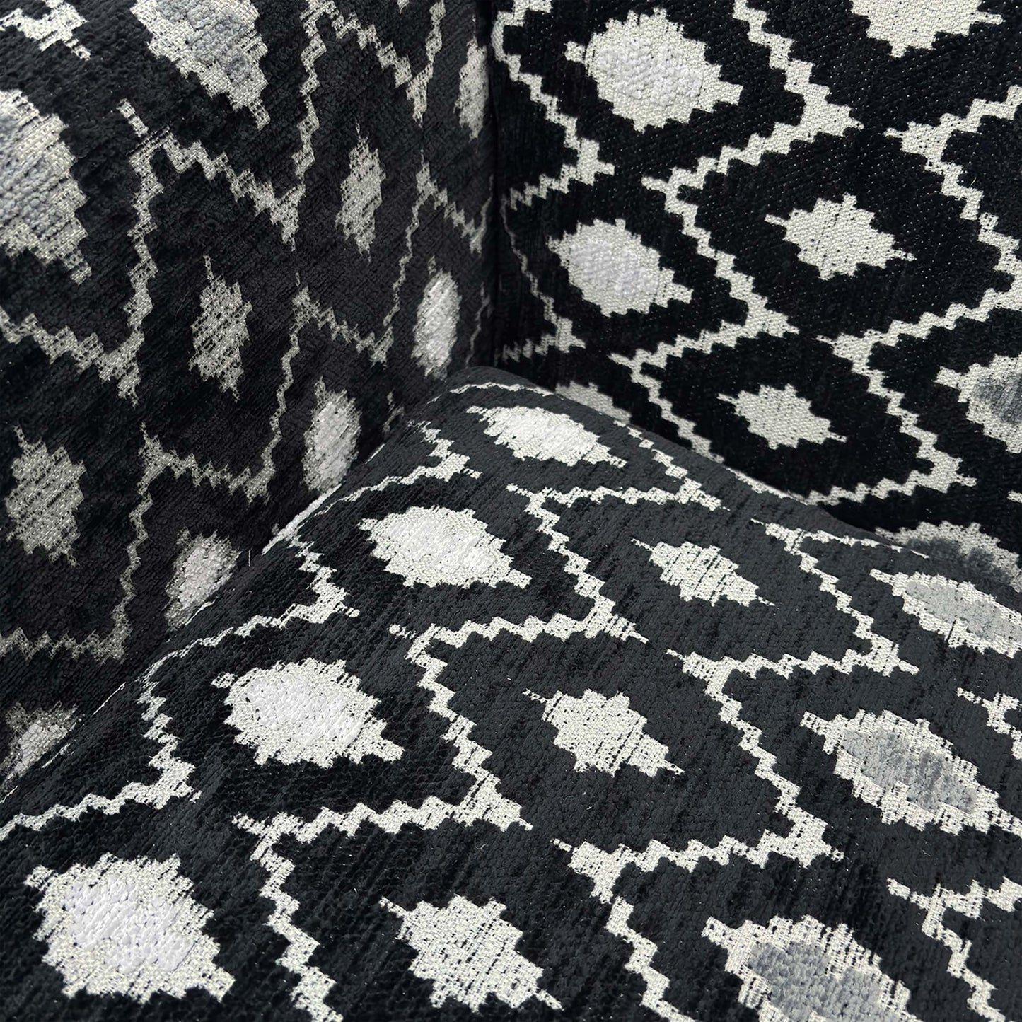 Close-up of the striking geometric diamond pattern fabric and high-quality upholstery work.