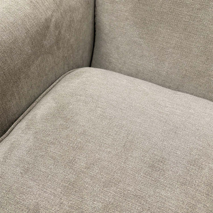 Close-up shot of the soft grey upholstery fabric, emphasizing the high-quality weave and texture.