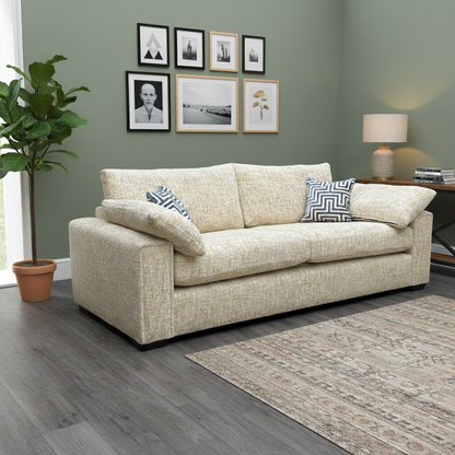 Living Room view of the marzipan cream 4-seater sofa, highlighting its long silhouette and structured design.