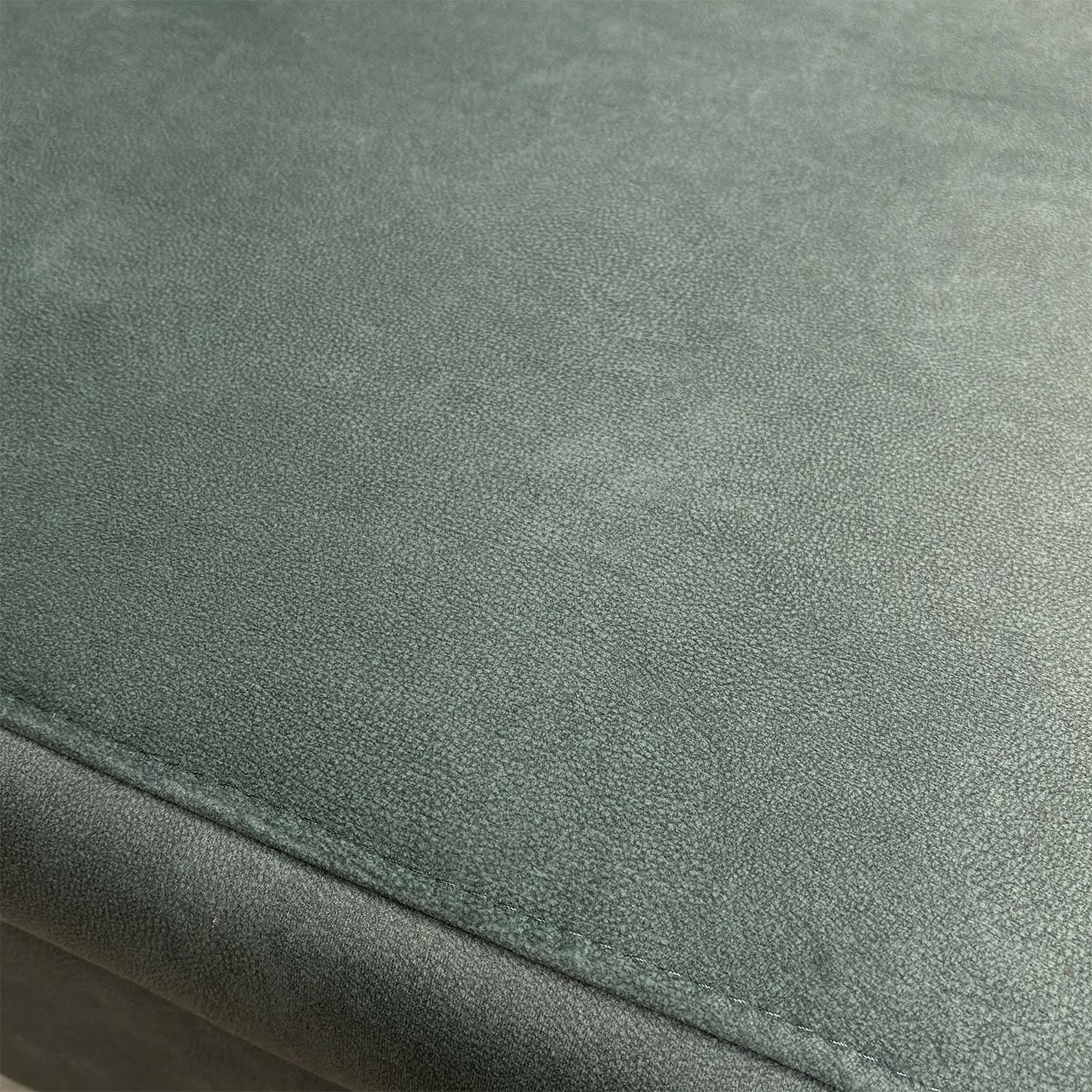 Detailed shot of the 43514 fern green velvet upholstery fabric and high-quality stitching.