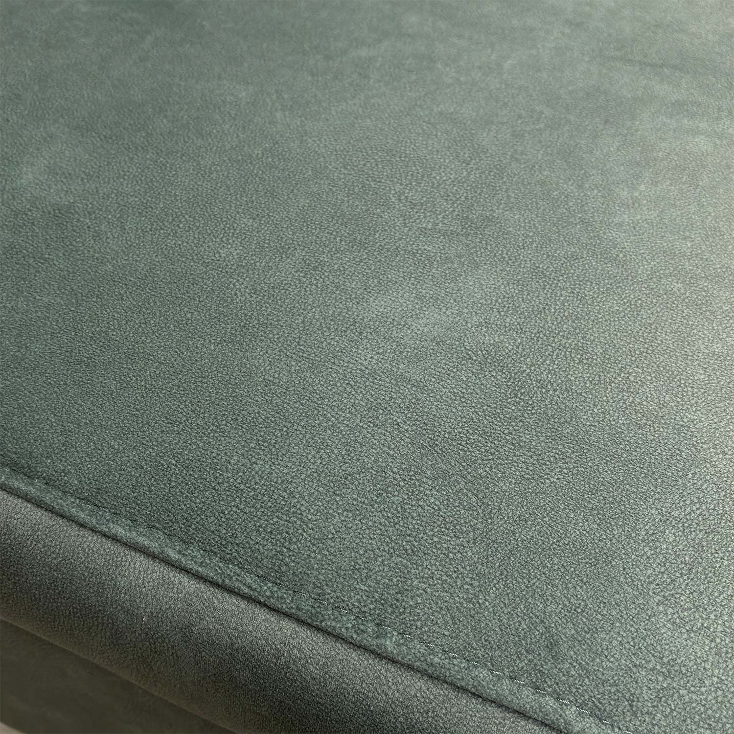Detailed shot of the 43514 fern green velvet upholstery fabric and high-quality stitching.